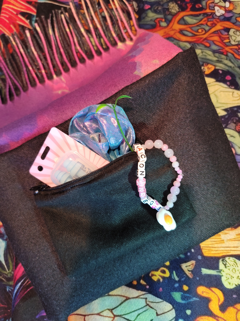 Pashmina showing hidden pocket with product inside such as earplugs and kandi